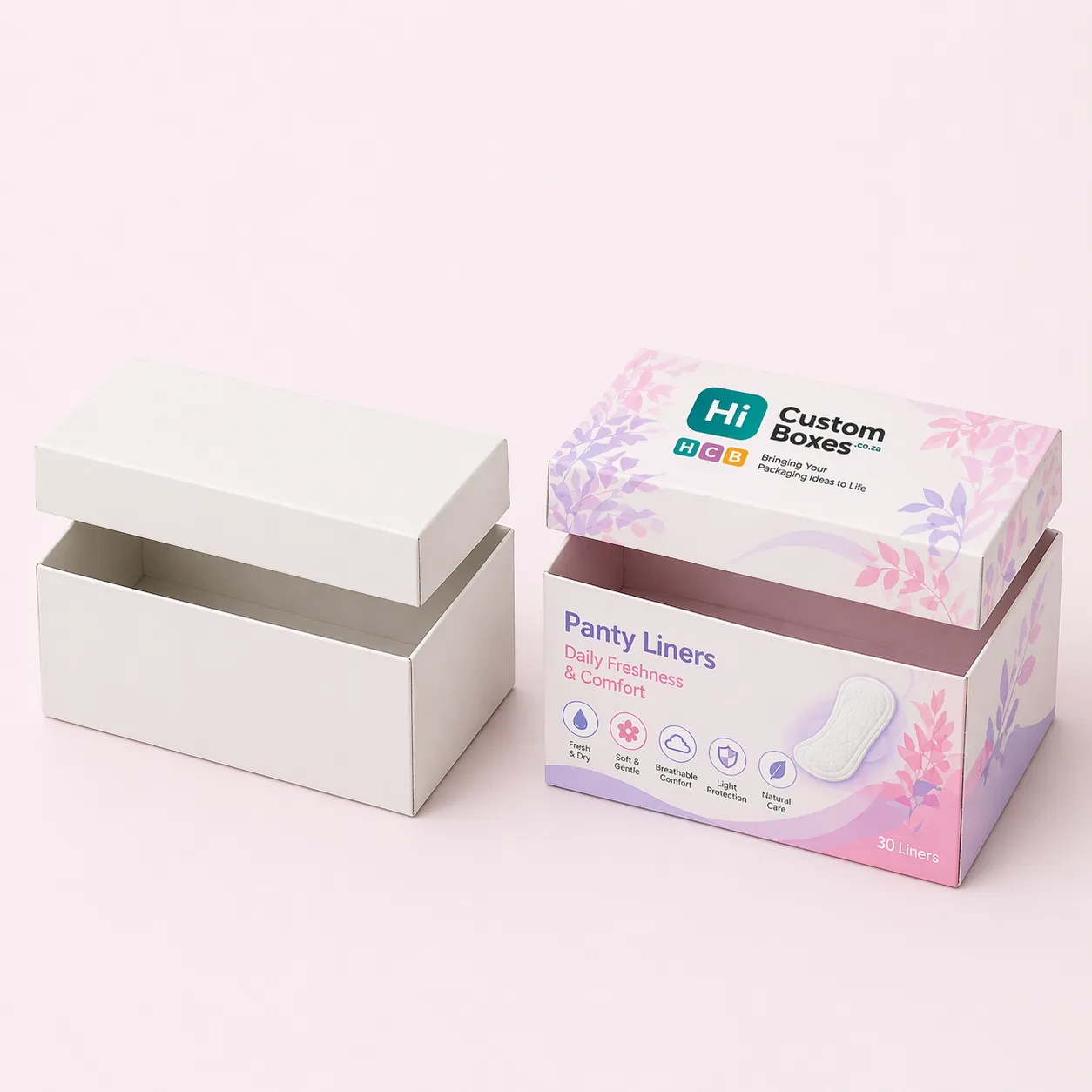 Two square mailing boxes, one white and one decorated with purple flowers and brand logo. class=